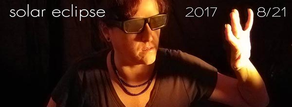 Facebook cover image from Kuypers wearing solar sunglasses in preparation for the total eclipse of the sun, image copyright © 2017-02018 Janet Kuypers