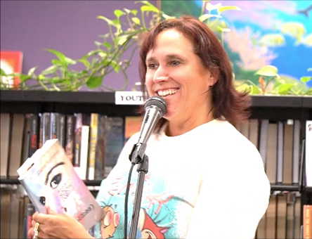 video still of Janet Kuypers reading from her book “(pheromemes) 2015-2017 show poems” live