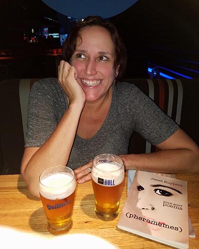 photo of Janet Kuypers with her book “(pheromemes) 2015-2017 poems” at Bar Bull Resto-Pub in Buenos Aures