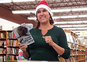 Janet Kuypers reading from the cc&d book “Flawed Cadaver” at her book reading feature in Austin 20171206, image copyright © 2017-2018 Janet Kuypers