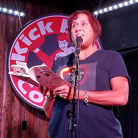 photo of Janet Kuypers reading from her book “(pheromemes) 2015-2017 poems” live