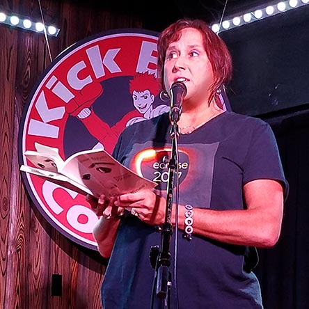 photo of Janet Kuypers reading from her book “(pheromemes) 2015-2017 poems” live