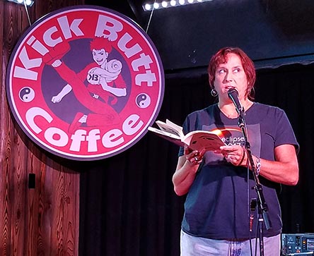 photo of Janet Kuypers reading from her book “(pheromemes) 2015-2017 poems” live