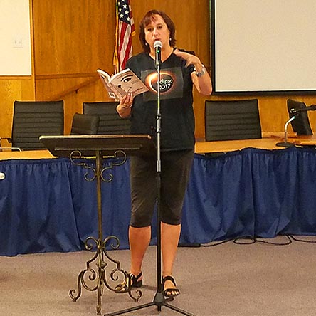 photo of Janet Kuypers reading from her book “(pheromemes) 2015-2017 poems” live