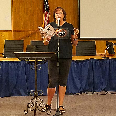 photo of Janet Kuypers reading from her book “(pheromemes) 2015-2017 poems” live