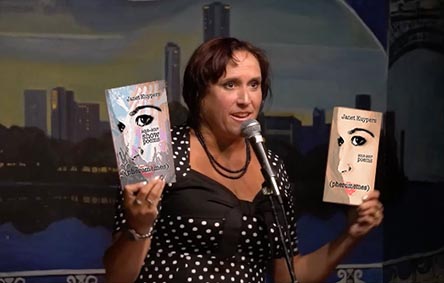 video still of Janet Kuypers reading from her books “(pheromemes) 2015-2017 poems” and “(pheromemes) 2015-2017 show poems” live