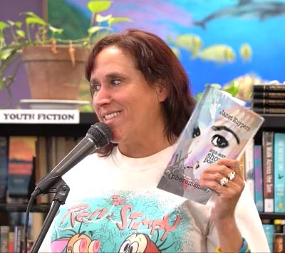 video still of Janet Kuypers reading from her book “(pheromemes) 2015-2017 show poems” live