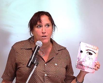 video still of Janet Kuypers reading from her book “(pheromemes) 2015-2017 show poems” live
