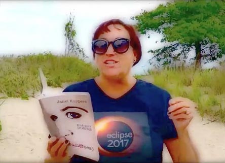 video still of Janet Kuypers reading from her book “(pheromemes) 2015-2017 poems” live