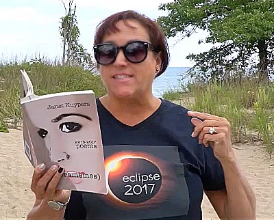 video still of Janet Kuypers reading from her book “(pheromemes) 2015-2017 poems” live
