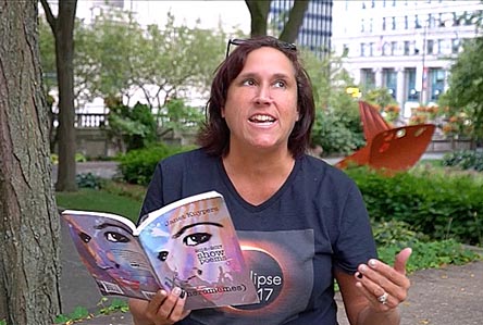 video still of Janet Kuypers reading from her book “(pheromemes) 2015-2017 show poems” live