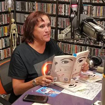 video still of Janet Kuypers reading from her book “(pheromemes) 2015-2017 poems” live