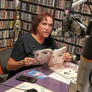 video still of Janet Kuypers reading from her book “(pheromemes) 2015-2017 poems” live