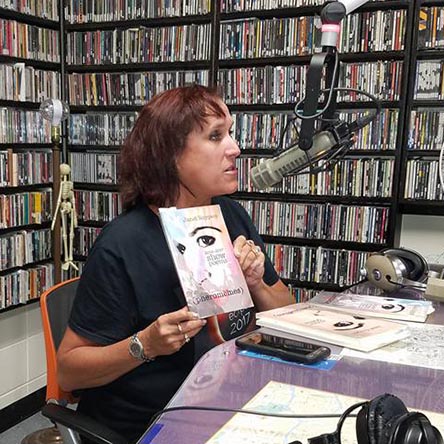 video still of Janet Kuypers reading from her book “(pheromemes) 2015-2017 show poems” live