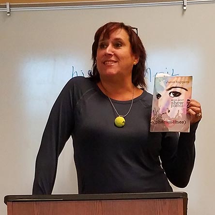 video still of Janet Kuypers reading from her book “(pheromemes) 2015-2017 show poems” live