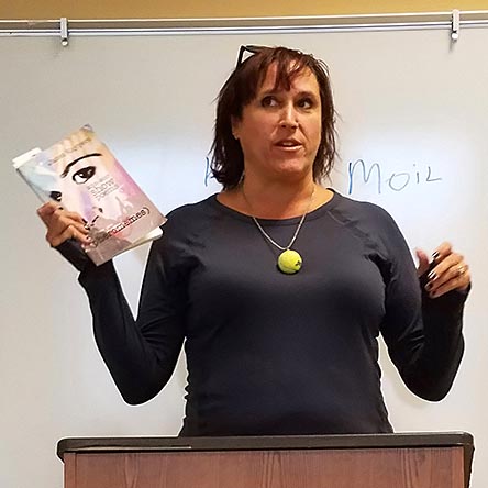 video still of Janet Kuypers reading from her book “(pheromemes) 2015-2017 show poems” live