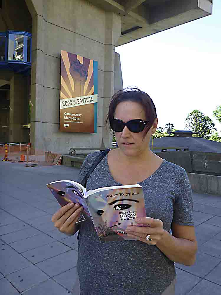 photo of Janet Kuypers with her book “(pheromemes) 2015-2017 show poems”